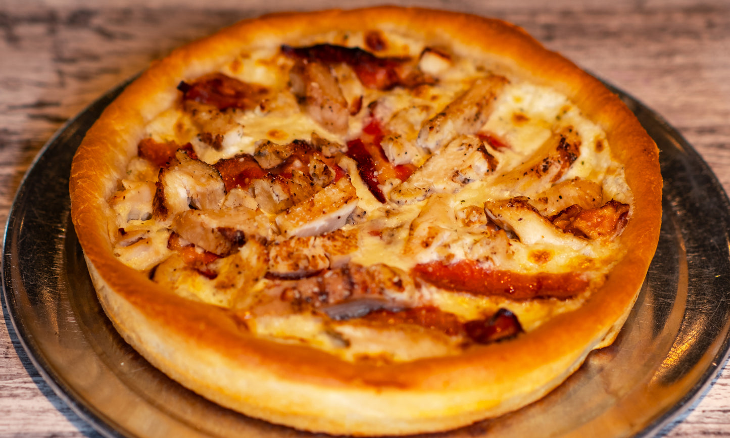 9-inch Chicago-style Deep Dish Chicken, Bacon, and Ranch pizza with cheese on the bottom, ranch sauce and chicken and bacon on top.