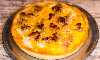9-inch Chicago-style Deep Dish Breakfast Sausage pizza with cheese on the bottom. Topped with cheese sauce, eggs, and breakfast sausage.