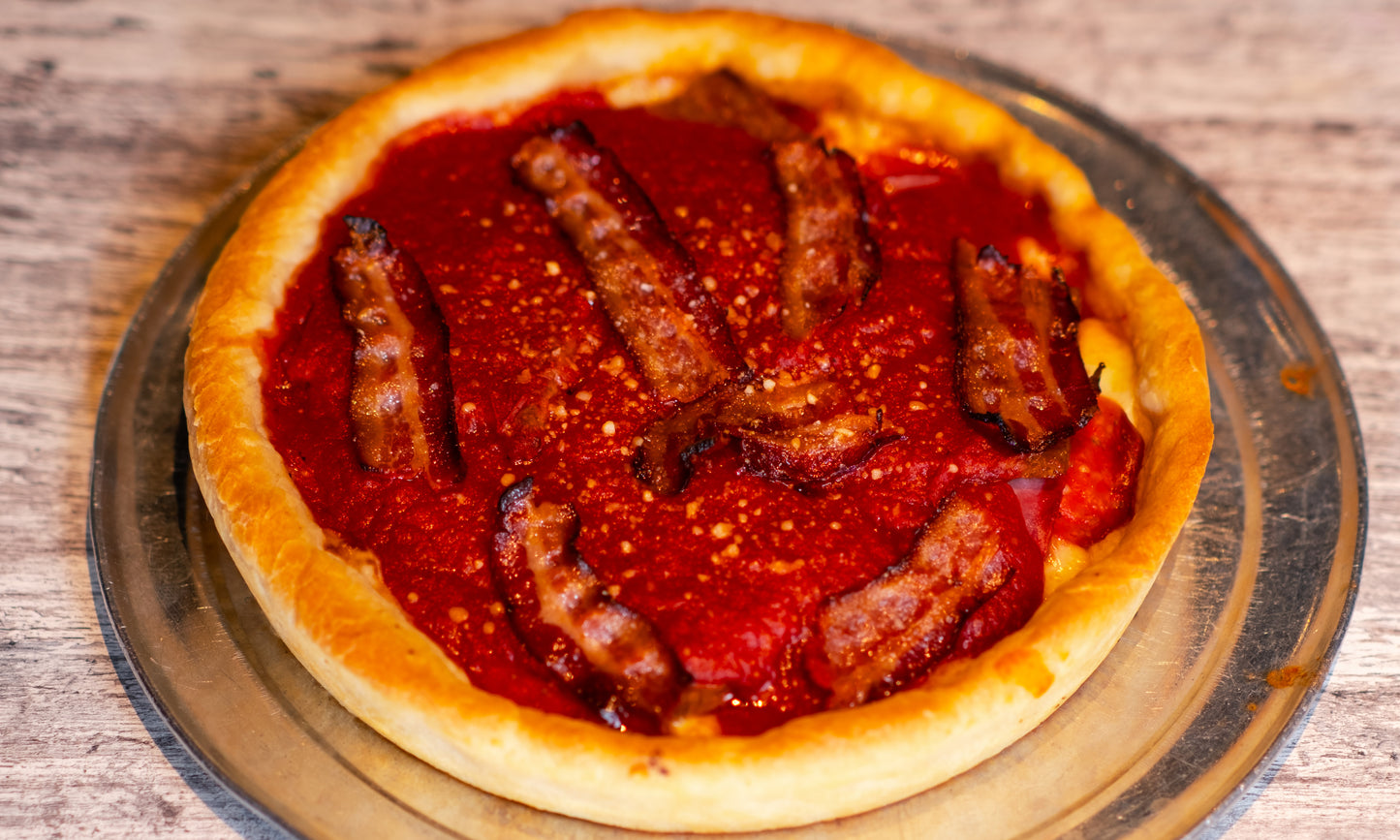 9-inch Chicago-style Deep Dish Meat Pie with cheese, pepperoni, ham, and Graziano's Italian sausage on the bottom and sauce and bacon on top.