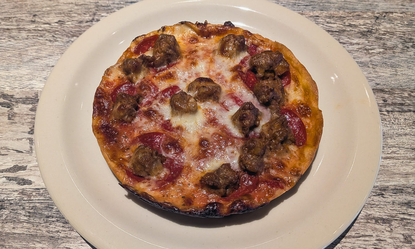 A Felix and Oscar's thin crust pizza with sausage and pepperoni.