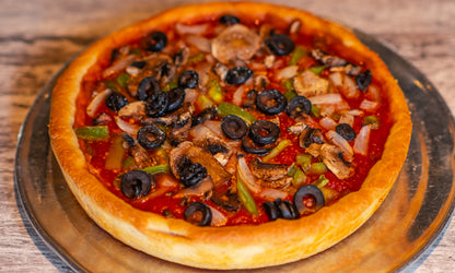 9-inch Chicago-style Deep Dish Veggie pizza with cheese on the bottom topped with sauce and onions, mushrooms, green peppers, and black olives.